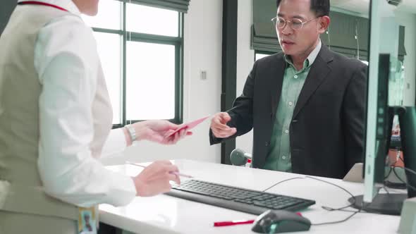 Smart businessman take check-in at he check-in counter at airport