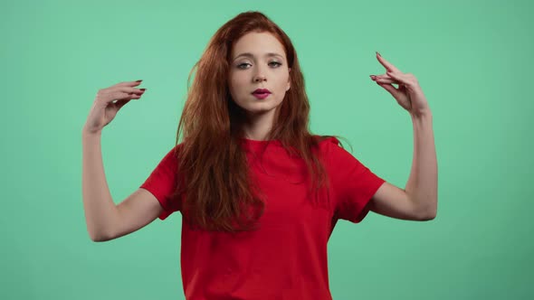 Pretty Woman Showing Blablabla Gesture with Hands and Rolling Eyes Isolated on Green Background