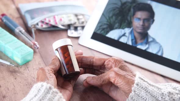 Rear View of Senior Women Online Consultation with Doctor on Digital Tablet