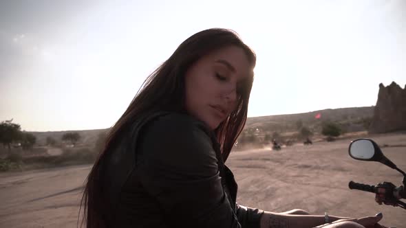 Cute Brunette with European Looks Denim Shorts Sitting on a Quad Bike in Cappadocia