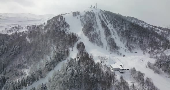 Aerial shot on skiing piste and snowy mountain