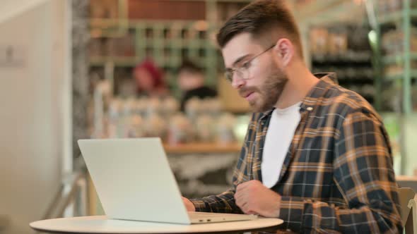 Young Man Closing Laptop and Going Away 