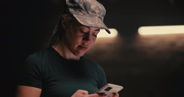 Female Soldier Browsing Mobile Phone