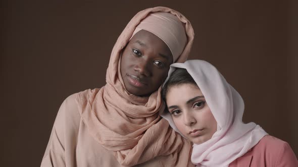 Two Young Diverse Muslim Women Wearing Traditional Clothes