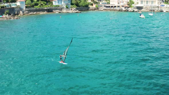 Drone View From Above Windsurfing Person in Blue Sealight Waves Large Surfacesunny Summer Day