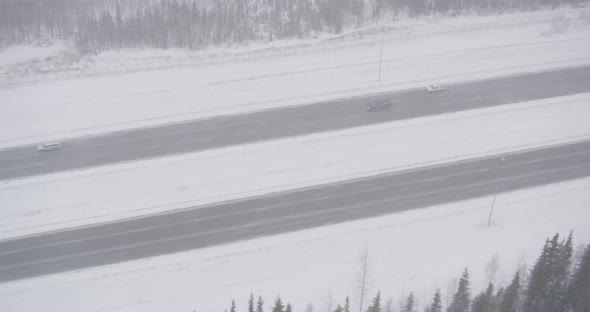 Aerial helicopter through snowy white hilltops, drone footage