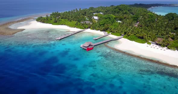 Natural fly over tourism shot of a white sand paradise beach and blue sea background 