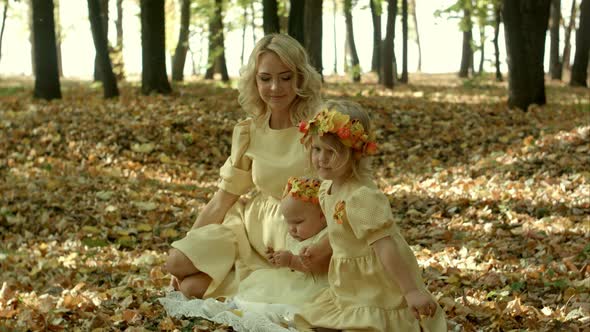 Mother with Children n in Sunny Autumn Park