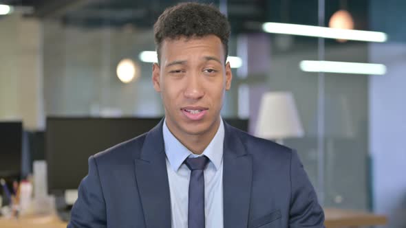 Portrait of Cheerful Young Businessman Showing Thumbs Up