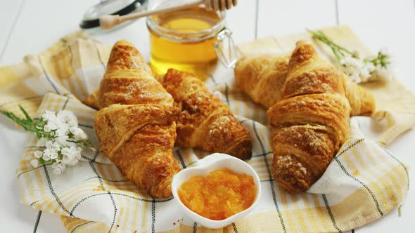 Condiments and Croissants Lying on Towel