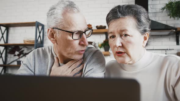 Aged Male and His Spouse Talking to Doctor By Laptop Using Online Video Call Coughing and