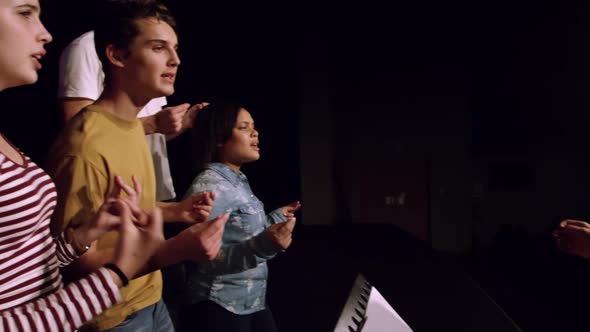 Teenagers rehearsing in a theatre