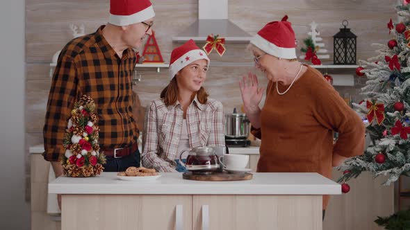 Happy Family Celebrating Winter Season Enjoying Christmas Holiday Standing at Table