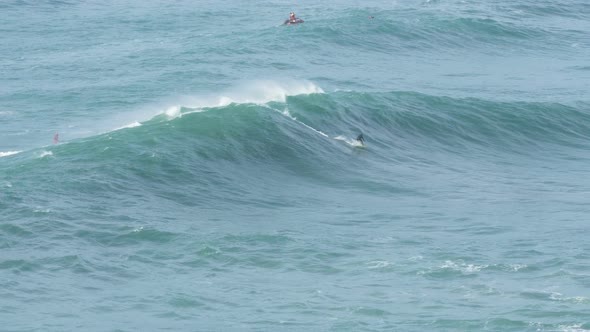 Rider on Scooter Pulls Surfer and Throws Rope on Huge Wave