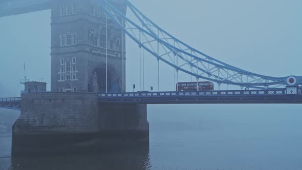 Coronavirus Covid-19 lockdown day one in foggy weather conditions at Tower Bridge in London, with Re