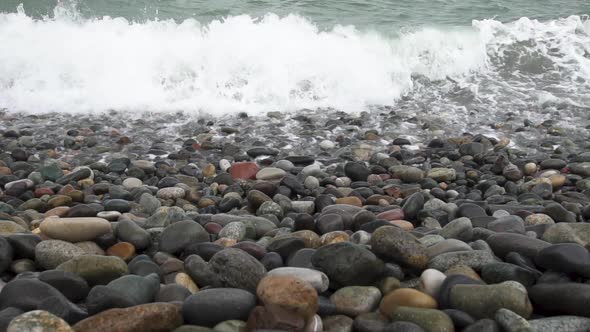 Sea Waves Roll on Pebbles Shore During a Light Storm Close Up Slow Motion Slow Motion