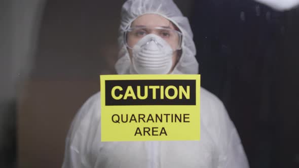 Woman in Protective Suit in Quarantine Zone. Coronovirus and Isolation Concept