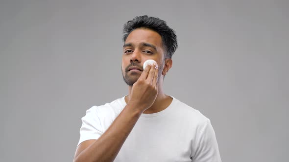 Smiling Indian Man Cleaning Face with Cotton Pad 8