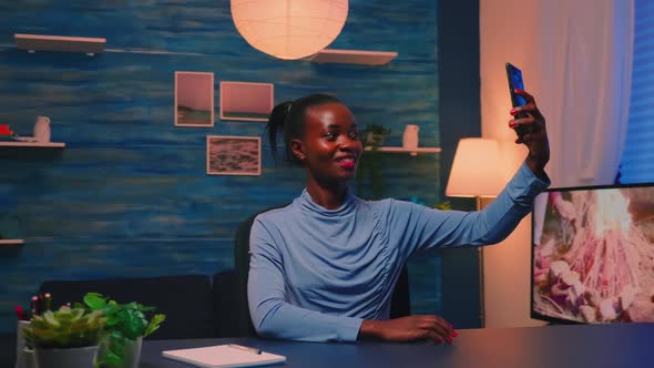 African Employee Taking a Selfie Using Mobile Phone Smiling at Camera