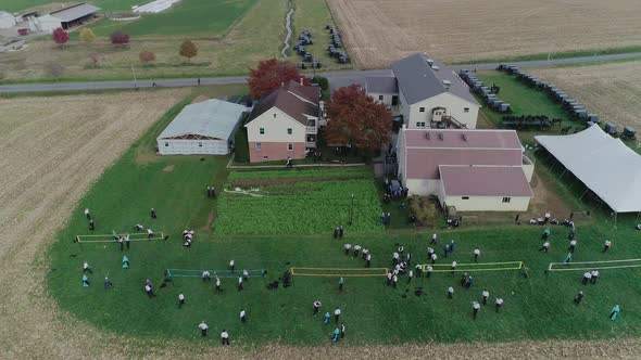 Ariel View of an Amish Wedding on an Autumn Day with Buggies, an Amish Playing Volley Ball as seen b
