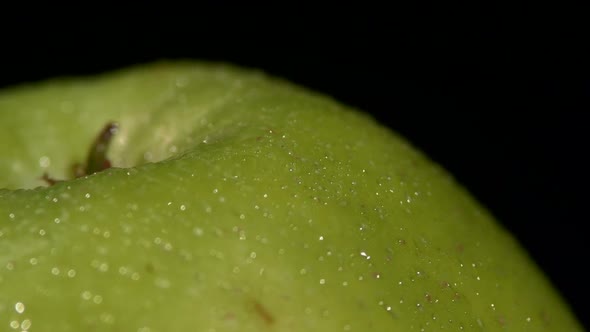 Side of Wet Green Apple Isolated on Black, Rotation Close Up