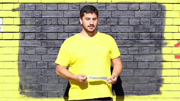 Slow motion shot of man with protective mask in front of grey wall