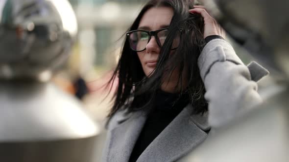 Adult Woman with Cup of Coffee to Go in City Center Modern Urban Landscape