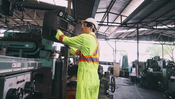 Smart Factory Worker Using Machine in Factory Workshop