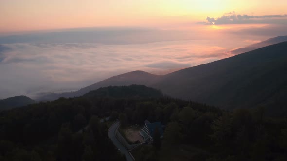 Aerial view of a foggy valley in Transylvania at sunset