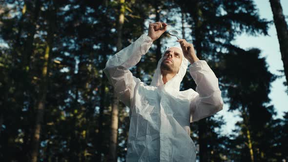 Plant Biologist Inspecting the Leaf of a Tree in the Mountains