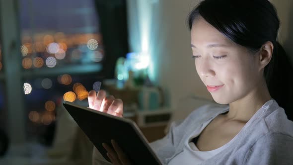 Woman using tablet computer at home 