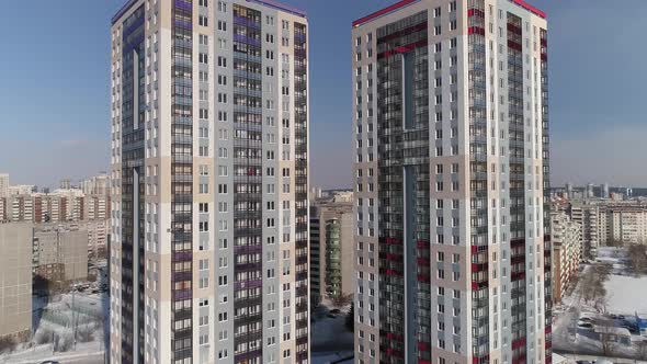 Aerial view of two new modern high-rise buildings with a playground and parking lot 14