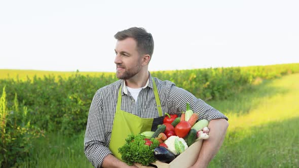 Farmer Carrying Crate of Freshly Picked Vegetables