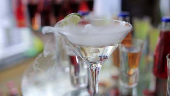 Smoking Martini Cocktail in a Conical Glass with Wafting Vapor