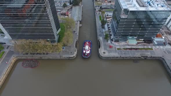 Aerial scene with drones. Boat leaving the city. Aerial camera from the front of the ship. Puerto Ma