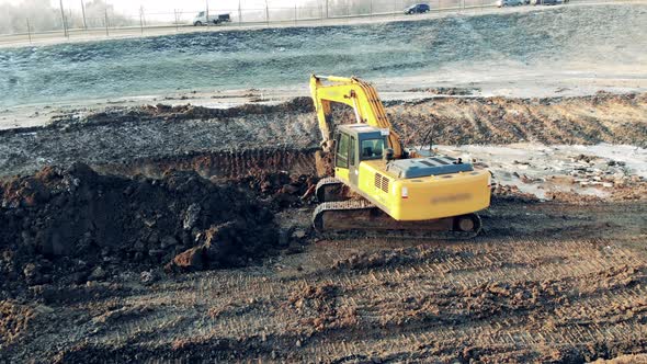 Excavator Is Digging Ground Next To the Motorway