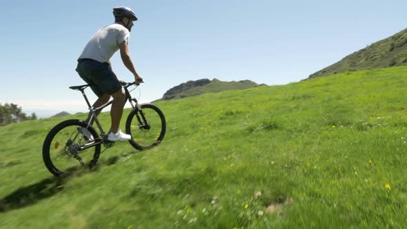 Young Man Ride Along By Mountain Bike in Outdoor Nature Mountain Scenery in Summer Day Gimbal
