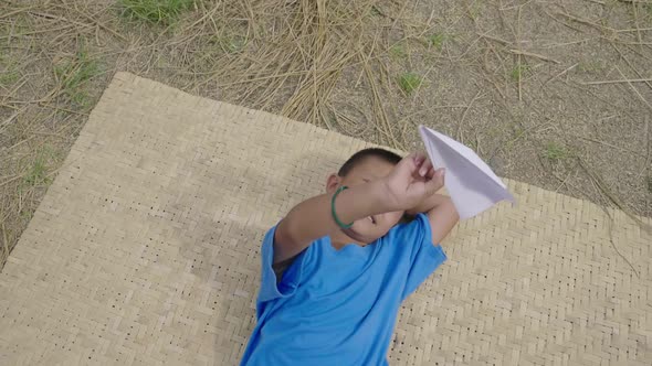 Kid Playing A Paper Airplane alt