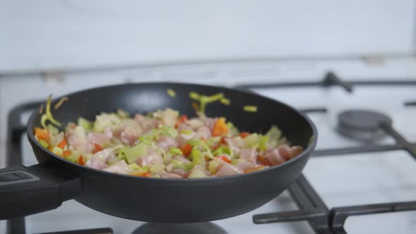 Mixing food in the pan. 