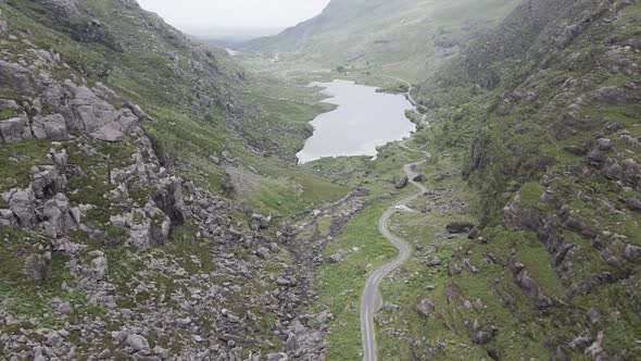 View Of A Lake By The Long Country Road In The Gap Of Dunloe, County Kerry, Ireland. - Aerial Drone