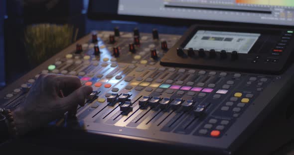 Sound Engineer Operating Mixing Console