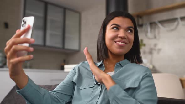 Cheerful Young Multiracial Woman Using Cell Phone for Video Call