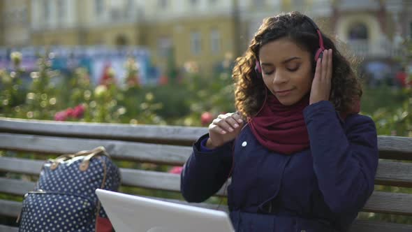 Beautiful Mixed Race Girl Enjoying Listening to Beloved Music Recordings Outdoor