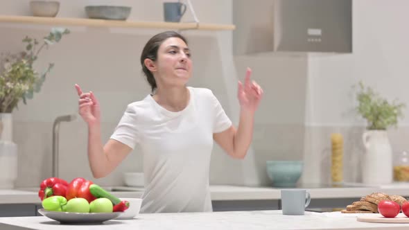 Indian Woman Dancing While Standing in Kitchen