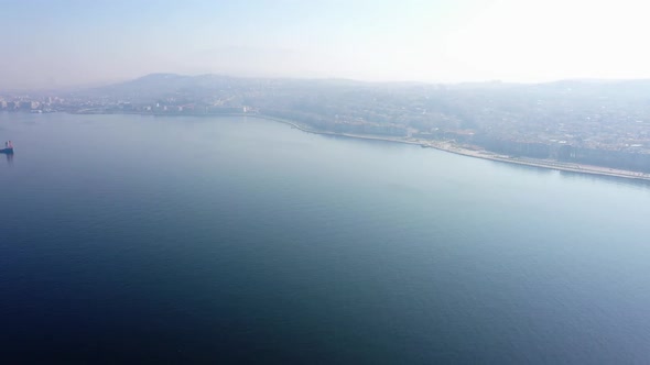 Aerial Drone View of Sea and Metropolis Buildings in the Morning