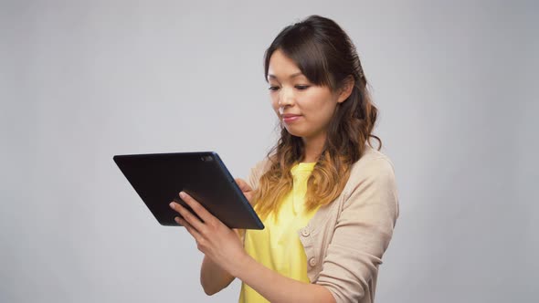 Asian Woman Using Tablet Computer