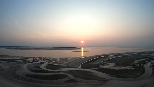 Drone shot of beautiful beach patters at the sunset - desceding drone shot