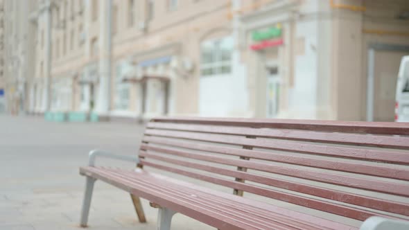 Old Woman Coming and Sitting on Bench Outdoor