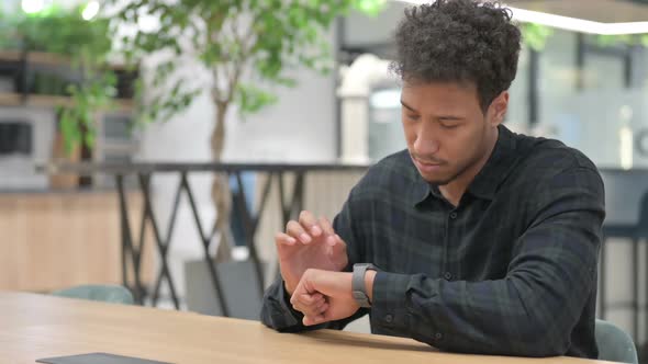 African American Man Using Smart Watch