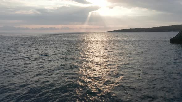 Backward Aerial Shot of the Vast Ocean Waters in Nusa Penida Islands at Sunset